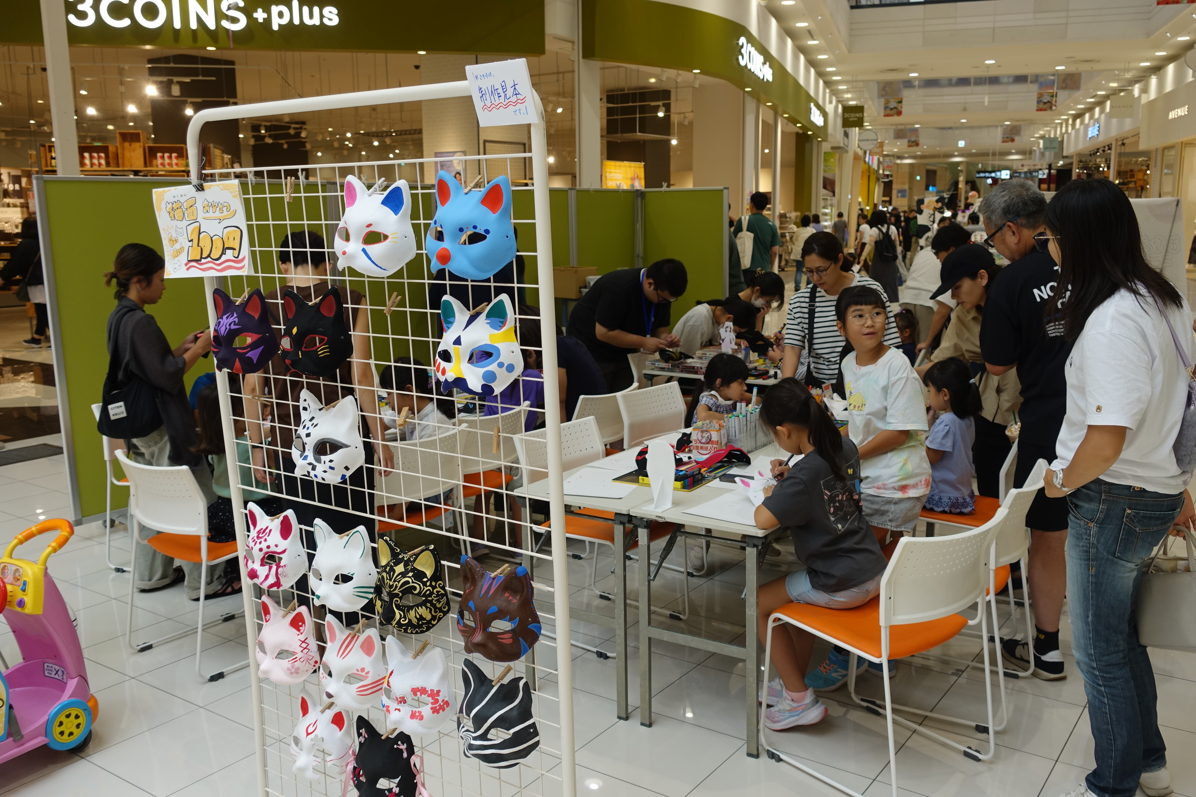 お面の色付け体験で楽しむ子どもたち